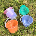 Two colorful, translucent mini buckets, handheld plastic buckets